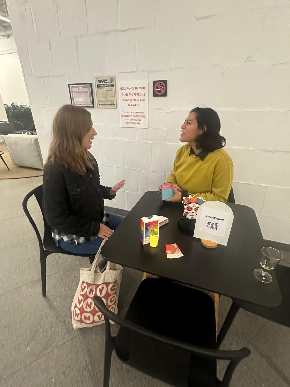 Kaide in conversation with a client at a small table